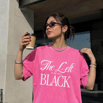 Woman wearing a pink t-shirt with white text: &amp;quot;The Left is the new BLACK&amp;quot;.