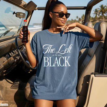Woman in denim t-shirt with text &amp;quot;The Left is the new BLACK&amp;quot; holding a drink.