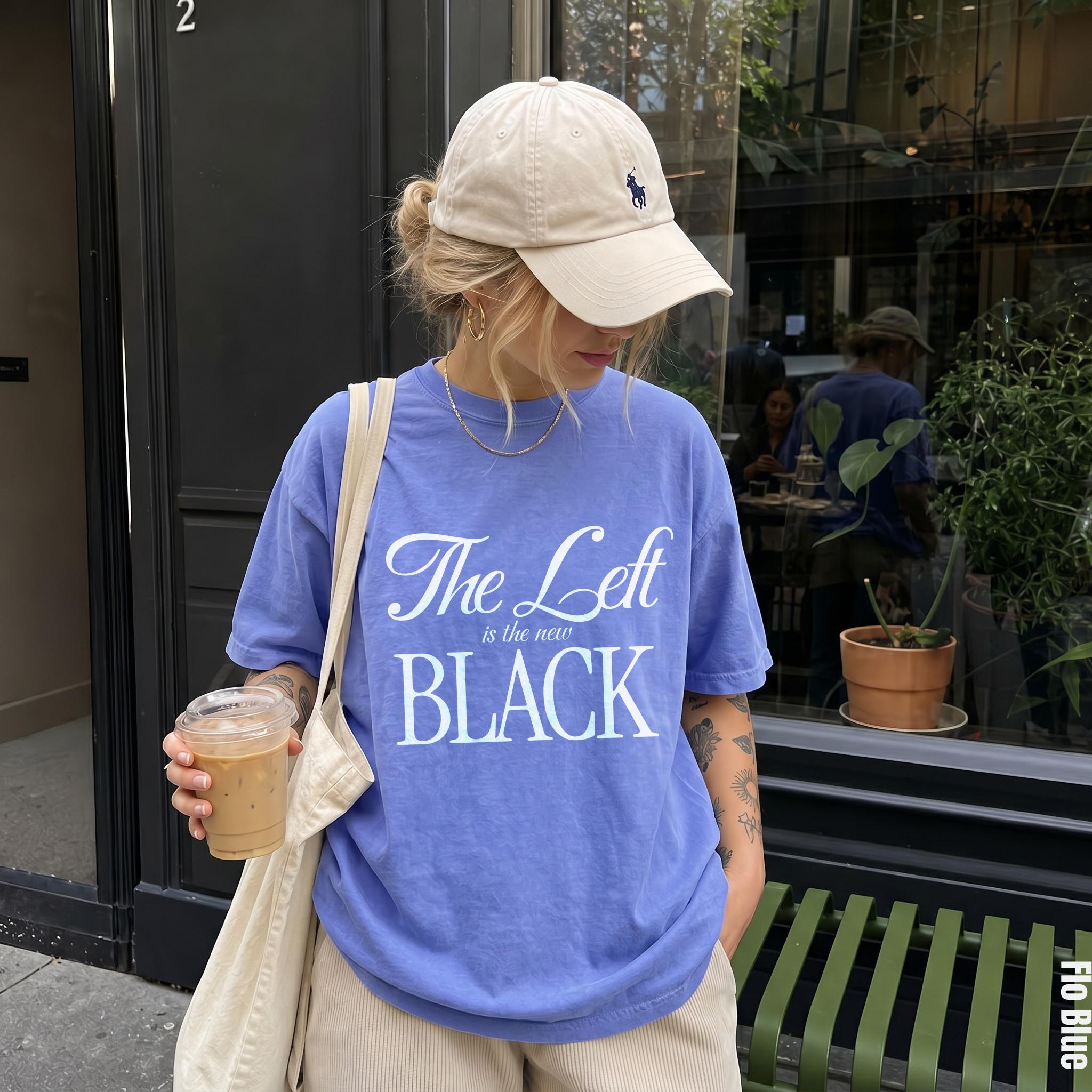 Purple t-shirt with white text &amp;quot;The Left is the new BLACK&amp;quot; and a tan baseball cap.