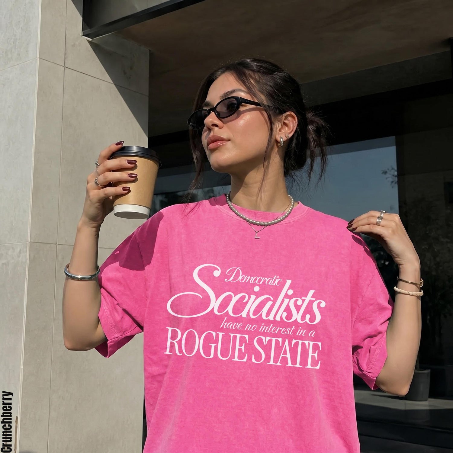 Woman in pink t-shirt with text &amp;quot;Democratic Socialists have no interest in a ROGUE STATE&amp;quot;.