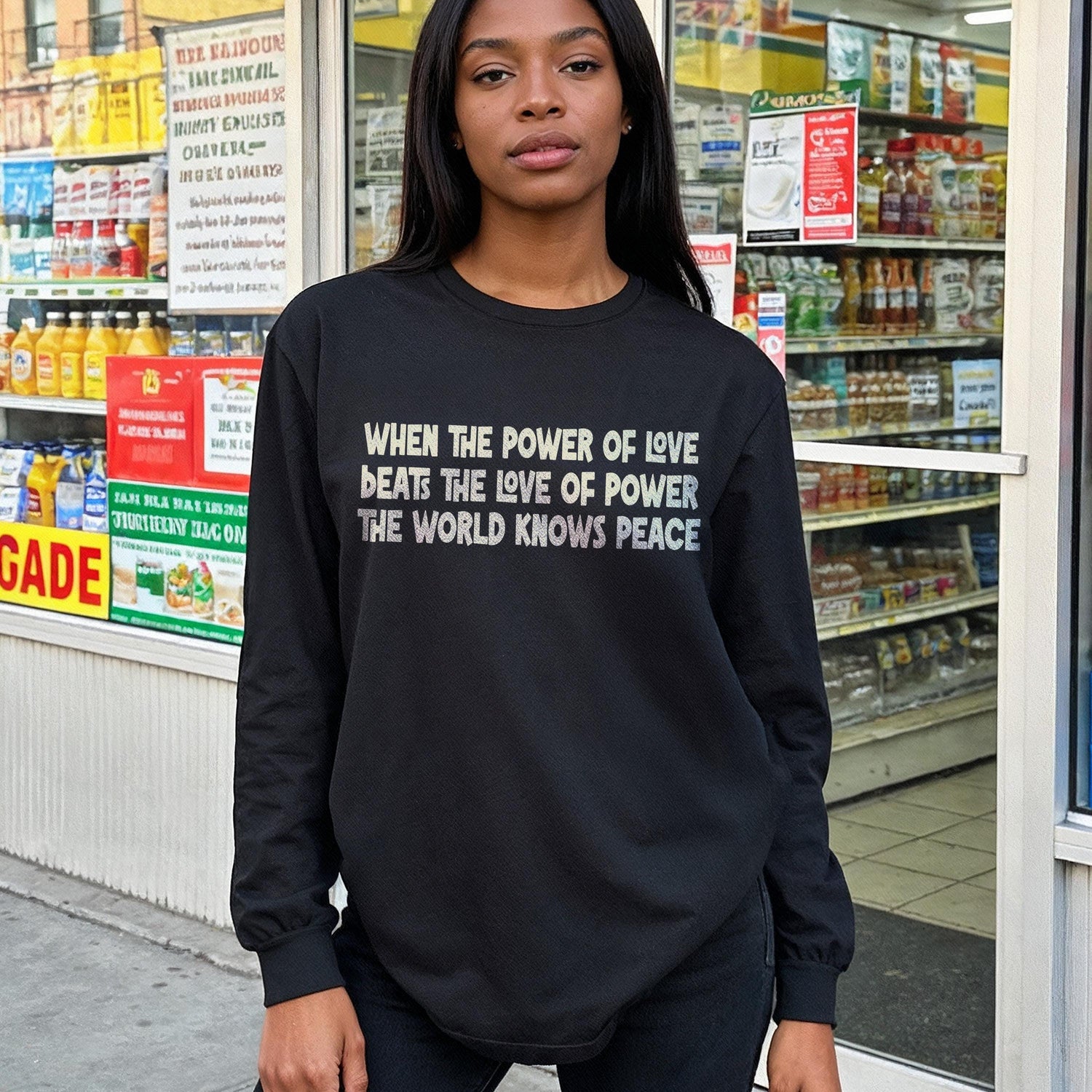 Black long-sleeve shirt with &amp;quot;When the power of love beats the love of power, the world knows peace&amp;quot; text.