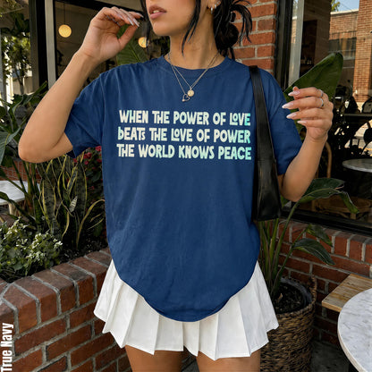 Navy t-shirt with &amp;quot;When the power of love beats the love of power, the world knows peace&amp;quot; text.