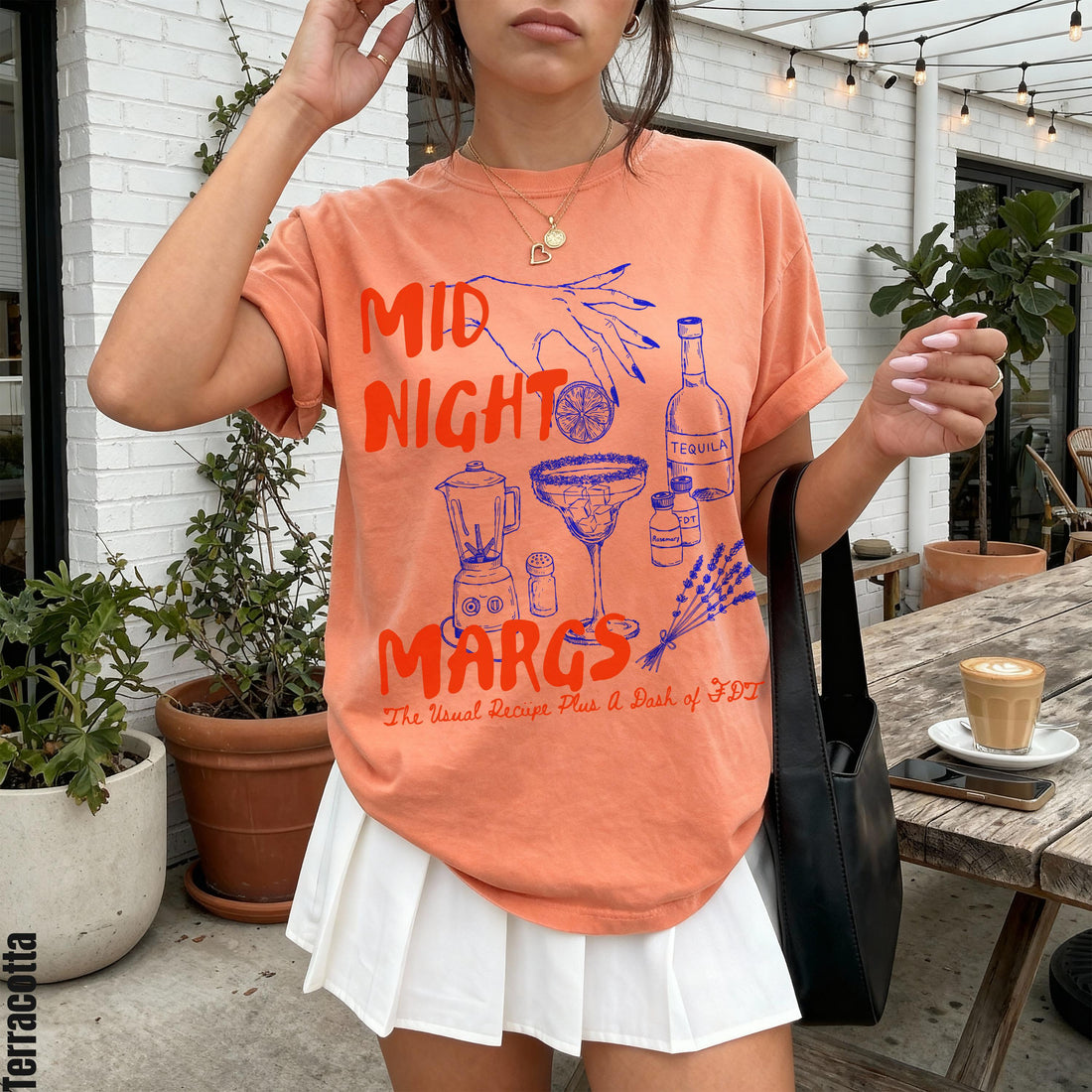 Orange t-shirt with &amp;quot;Midnight Margs&amp;quot; graphic featuring margarita ingredients and text.