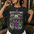 Black t-shirt with graphic of witches, cats, bats, and text "God Forbid We Have Hobbies."