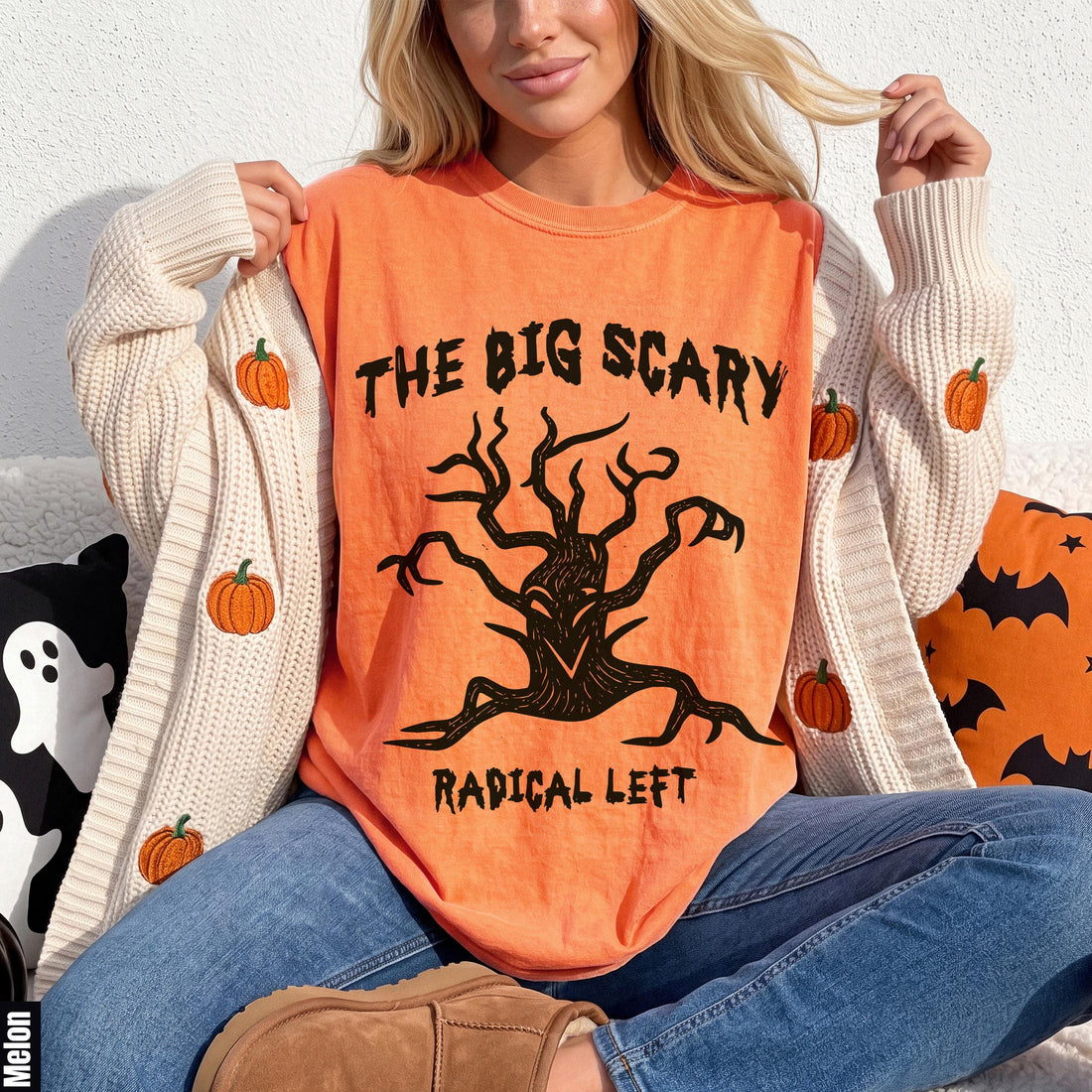 Orange t-shirt with black text and a spooky tree graphic.