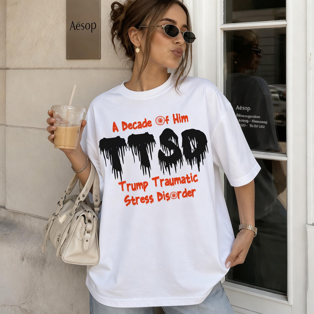 White t-shirt with black &amp;quot;TTSD&amp;quot; and red &amp;quot;A Decade of Him Trump Traumatic Stress Disorder&amp;quot; text.