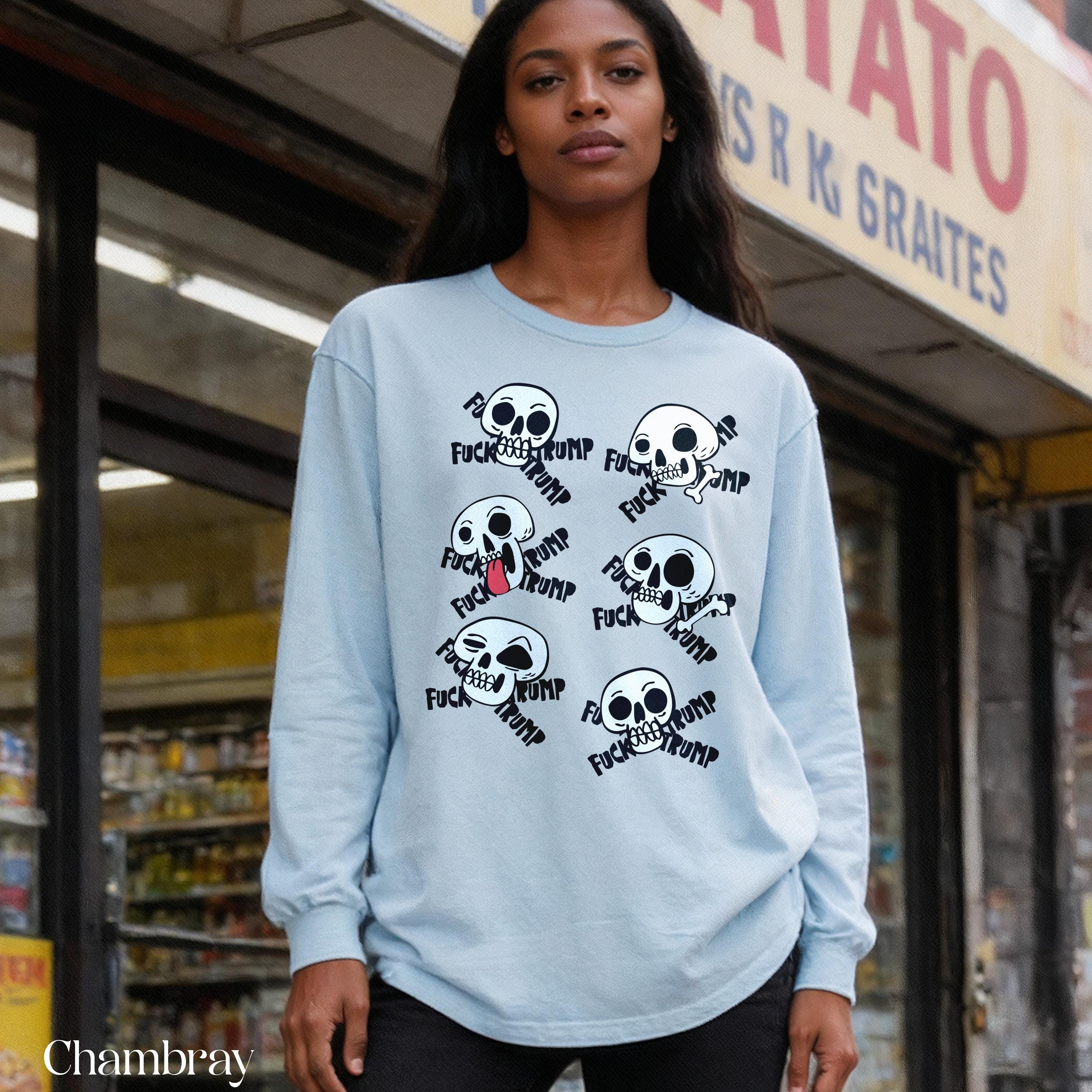 Light blue long-sleeved shirt with skulls and &amp;quot;fuck trump&amp;quot; graphic.