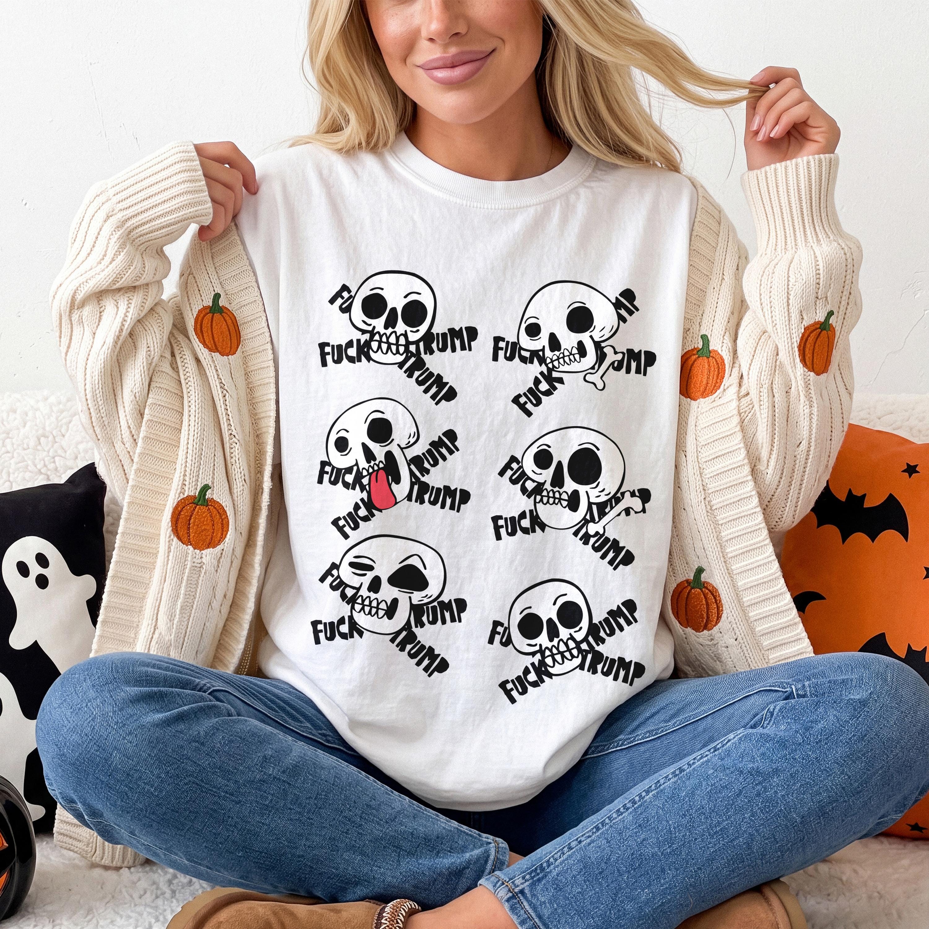 White t-shirt with six skulls and the text &amp;quot;Fuck Trump&amp;quot;.