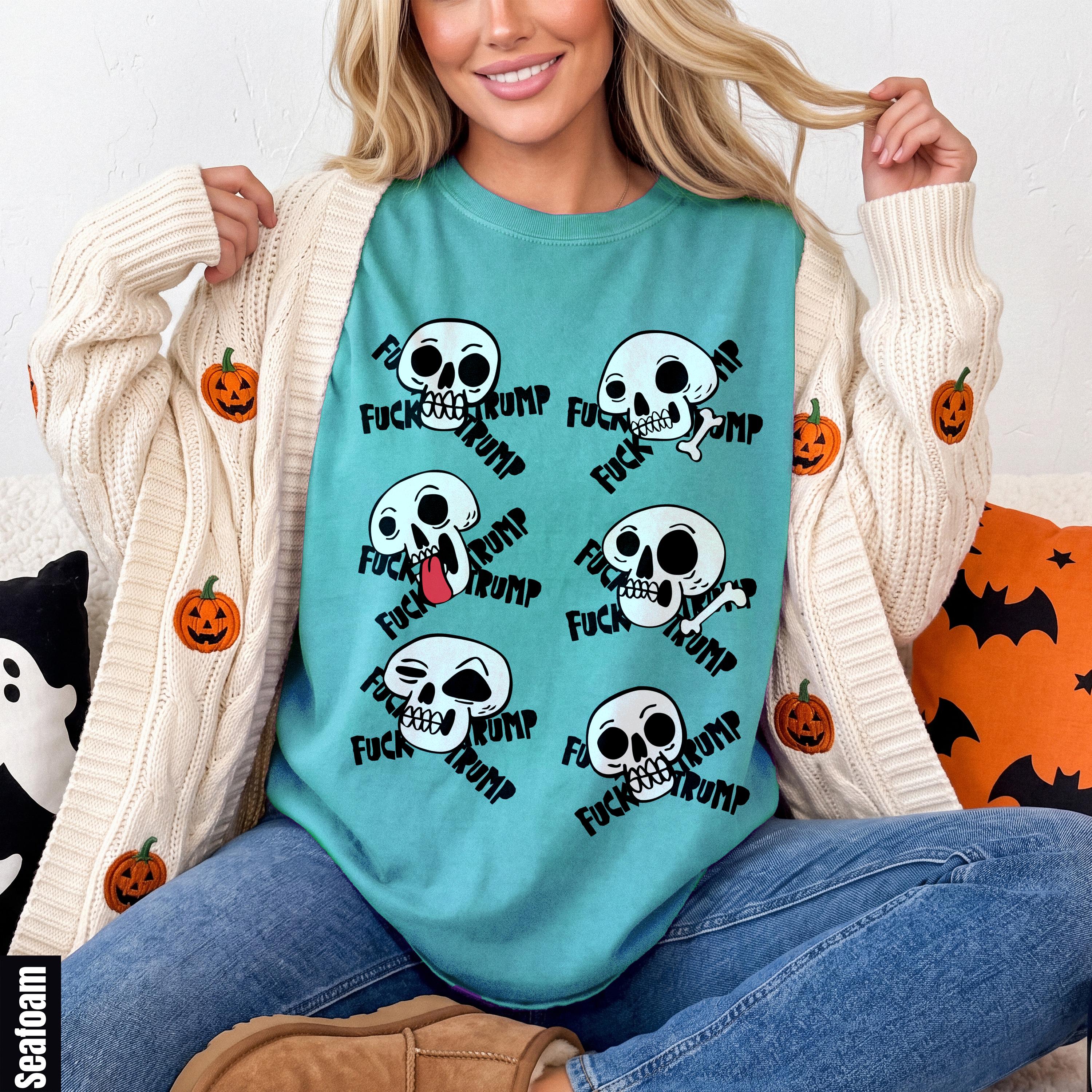 Teal t-shirt with scattered skull graphics and &amp;quot;FUCK TRUMP&amp;quot; text.