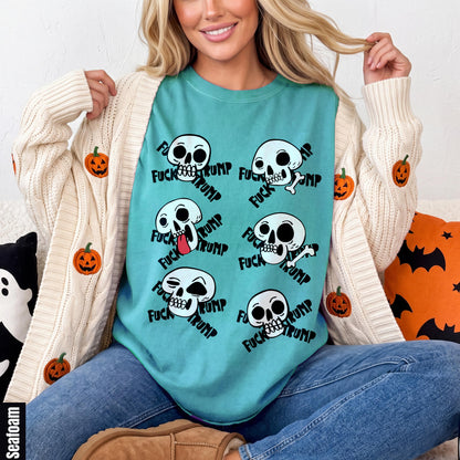 Teal t-shirt with scattered skull graphics and &amp;quot;FUCK TRUMP&amp;quot; text.