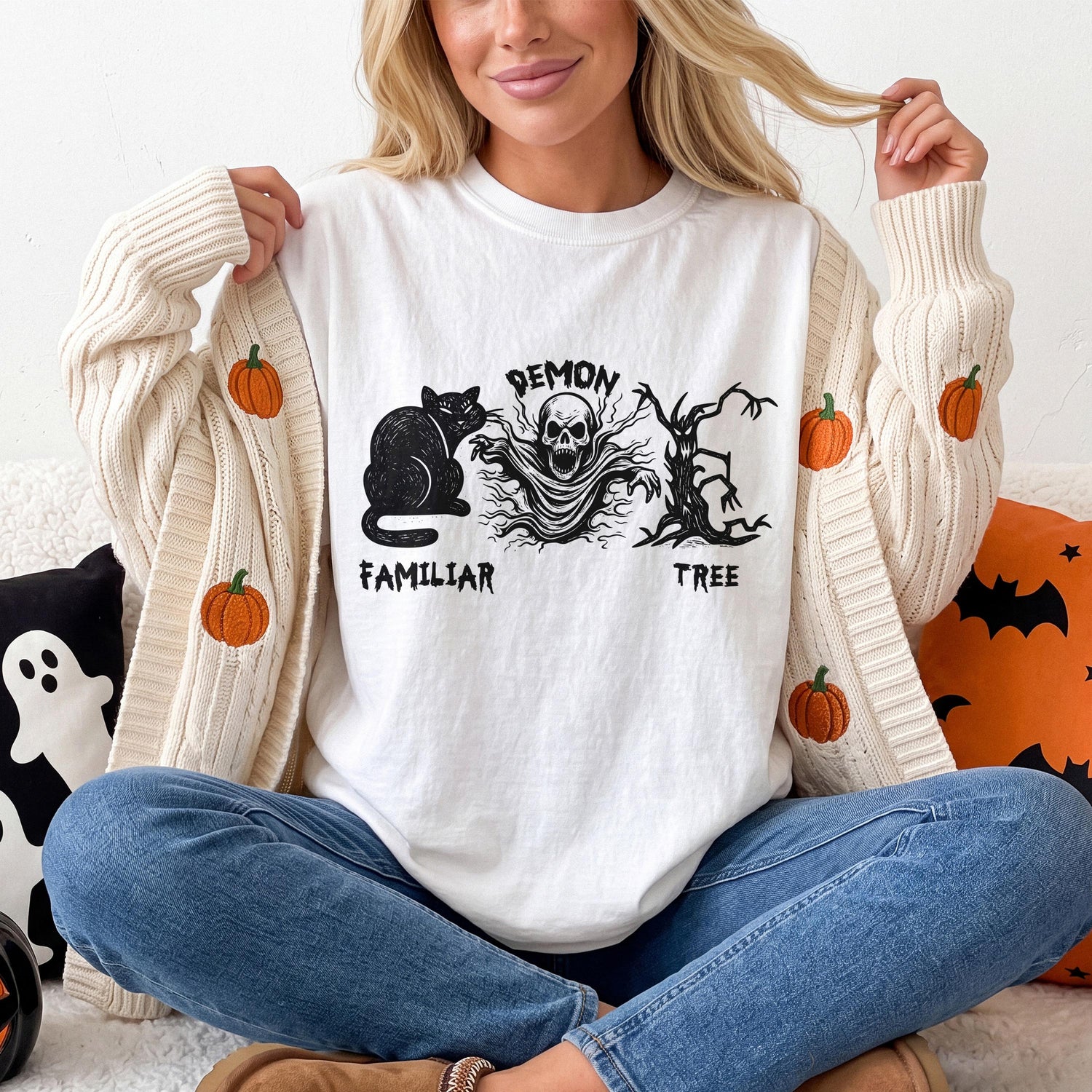 White t-shirt with black Halloween graphic: cat, demon skull, and tree.