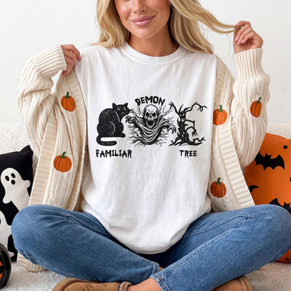White t-shirt with black Halloween graphic: cat, demon skull, and tree.