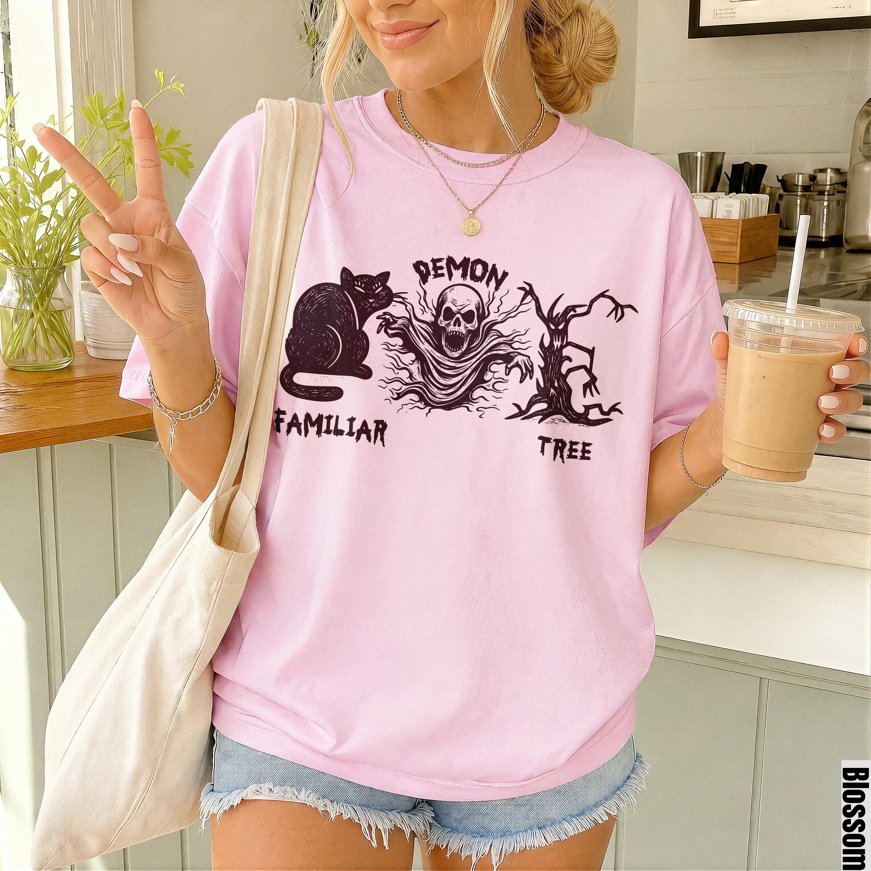 Pink t-shirt with black Gothic graphic: cat, skull, and tree with text.