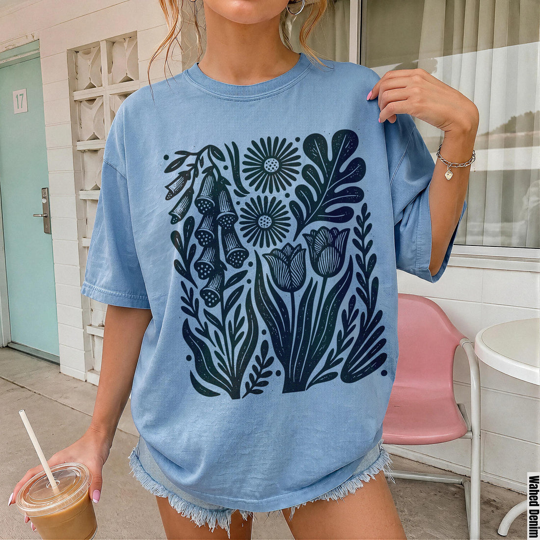 Blue t-shirt with a dark blue floral botanical print.