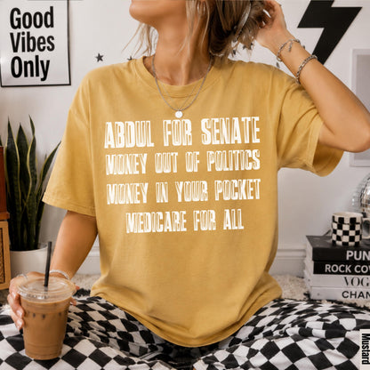 Yellow t-shirt with white text: Abdul for Senate, Money Out of Politics, Money In Your Pocket, Medicare for All.