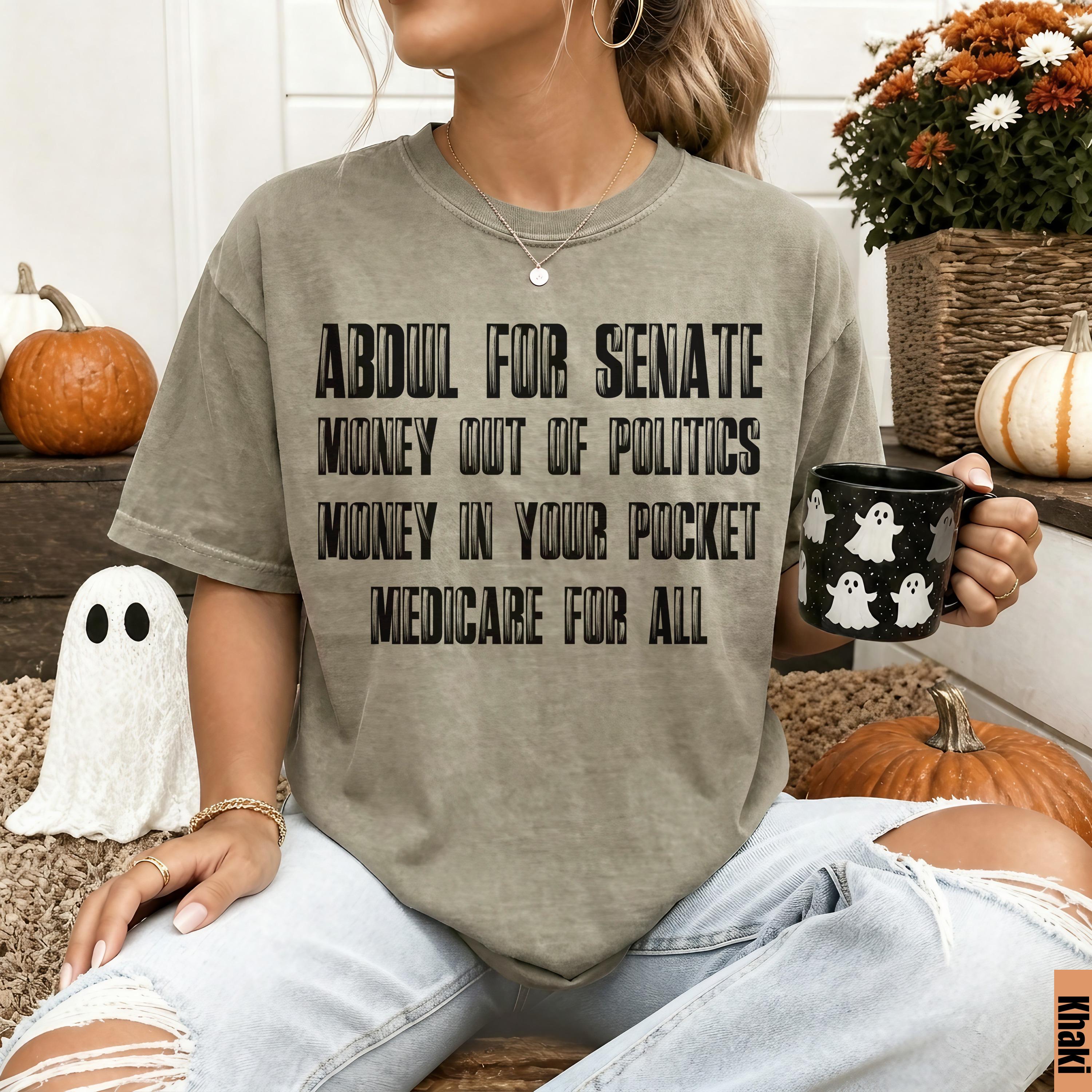 Khaki t-shirt with text &amp;quot;ABDUL FOR SENATE MONEY OUT OF POLITICS MONEY IN YOUR POCKET MEDICARE FOR ALL&amp;quot;.