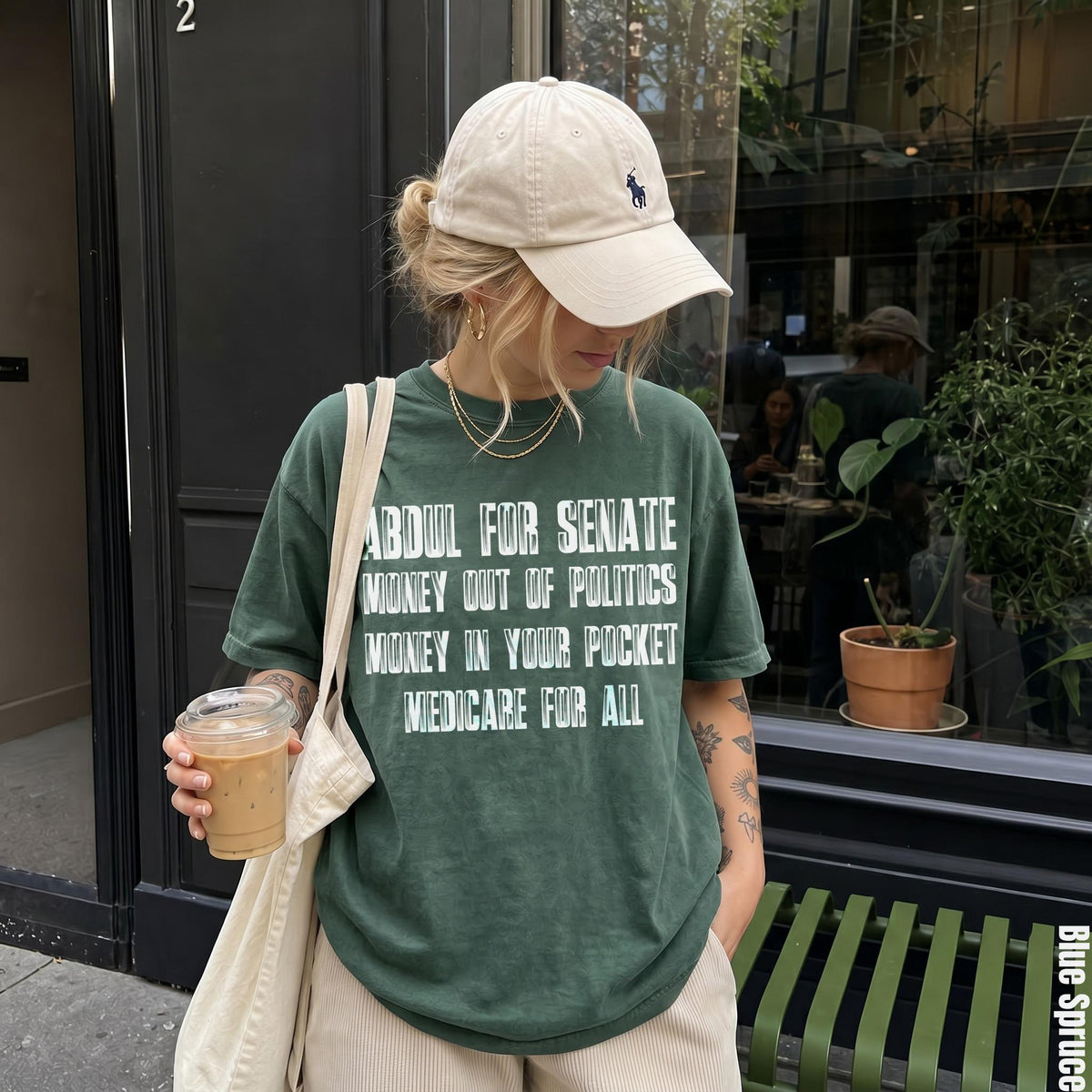 Green t-shirt with text: Abdul for Senate, Money out of politics, Money in your pocket, Medicare for all.