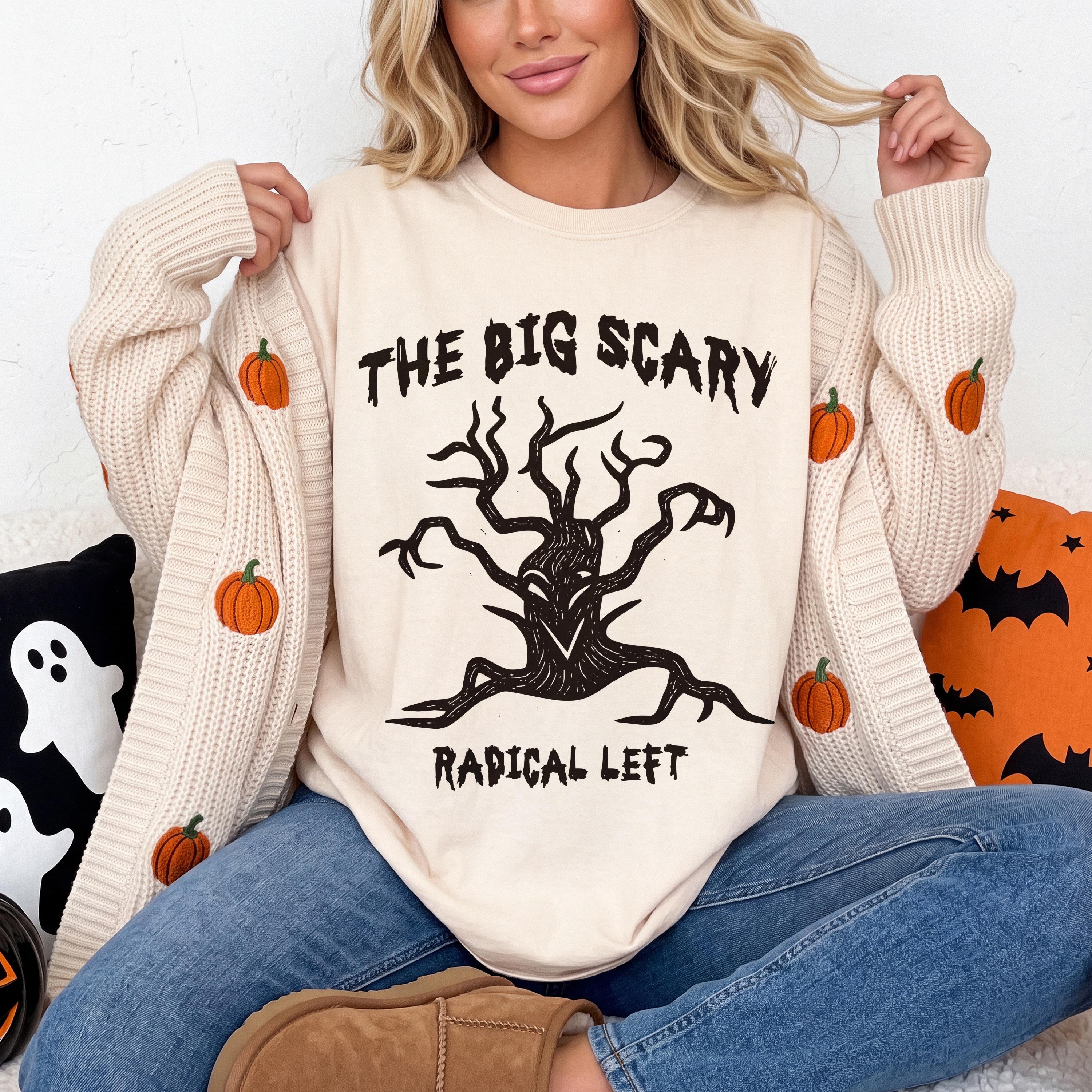 Cream sweater with embroidered pumpkins, black graphic tee with &amp;quot;The Big Scary Radical Left&amp;quot; text.