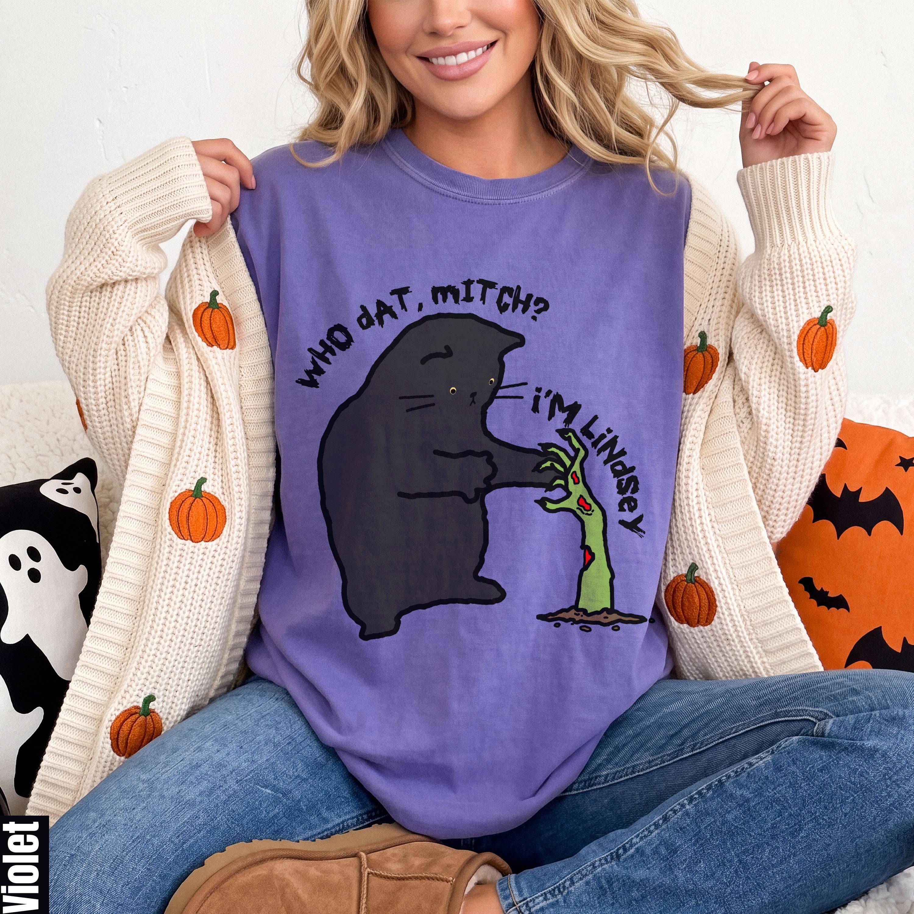 Purple t-shirt with black cat graphic that says &amp;quot;Who dat Mitch? I&amp;