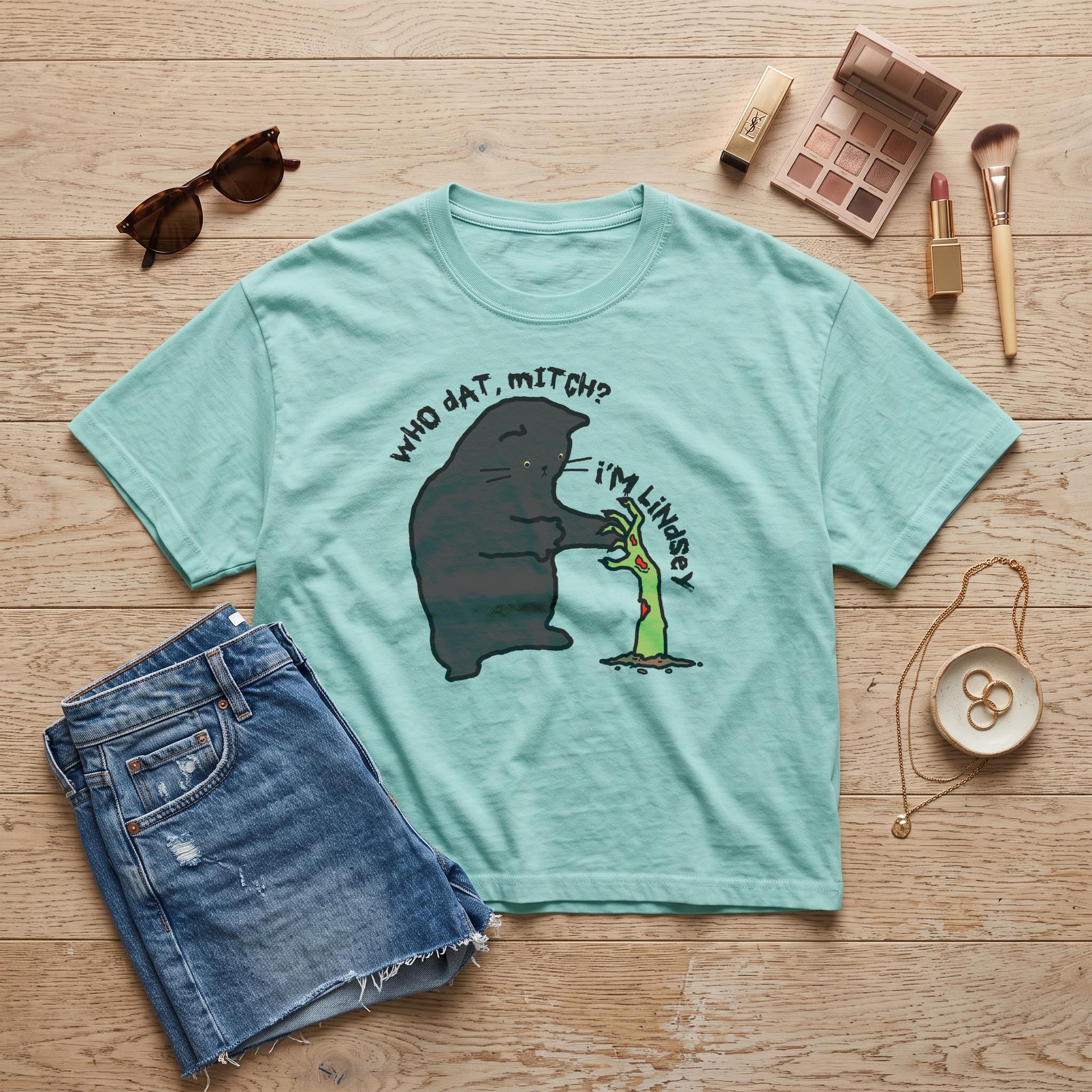 Teal t-shirt with a black cat reaching for a zombie hand graphic: &amp;quot;Who dat, Mitch? I&amp;