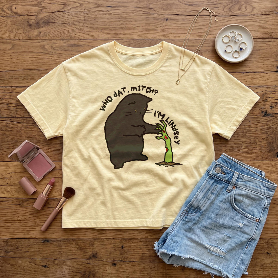 Yellow t-shirt with black cat and zombie hand graphic reads &amp;quot;Who dat, Mitch? i&amp;