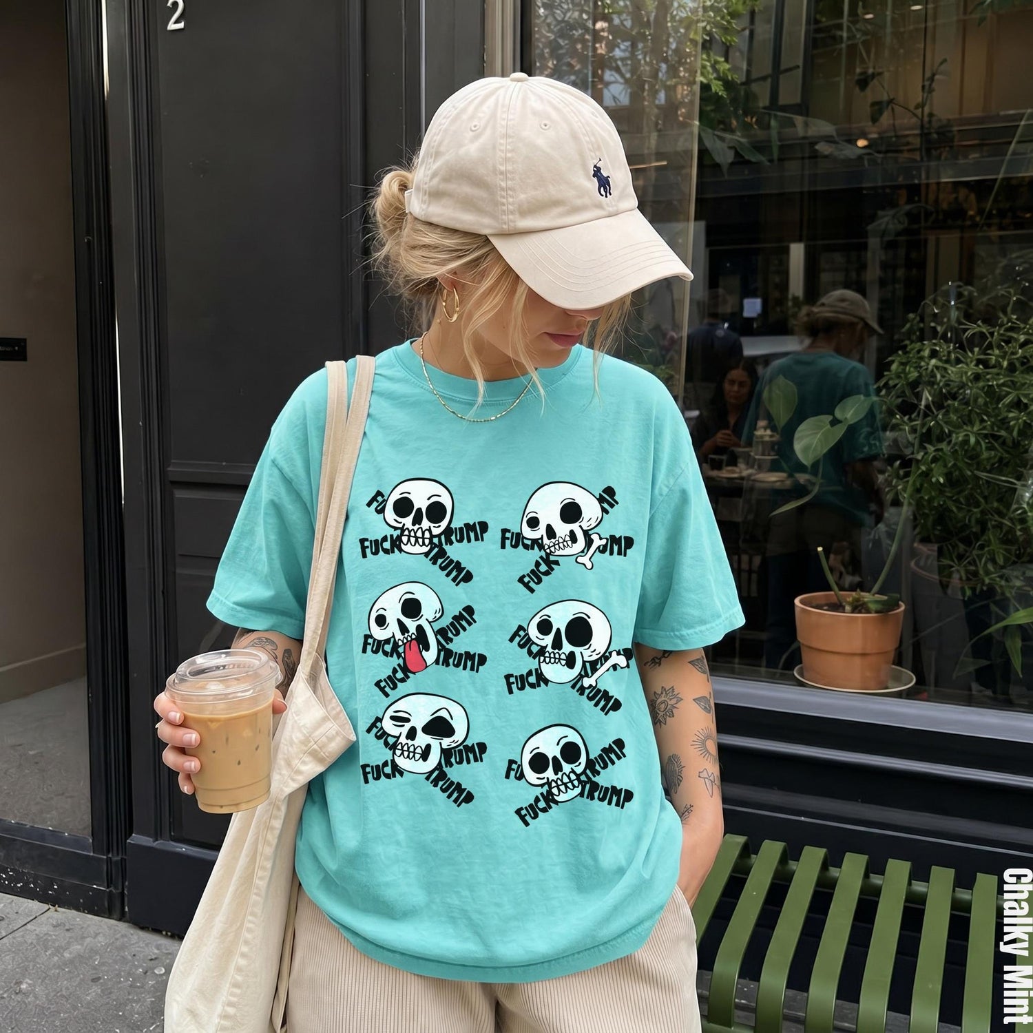 Turquoise t-shirt with multiple skull graphics and the text &amp;quot;FUCK TRUMP&amp;quot;.