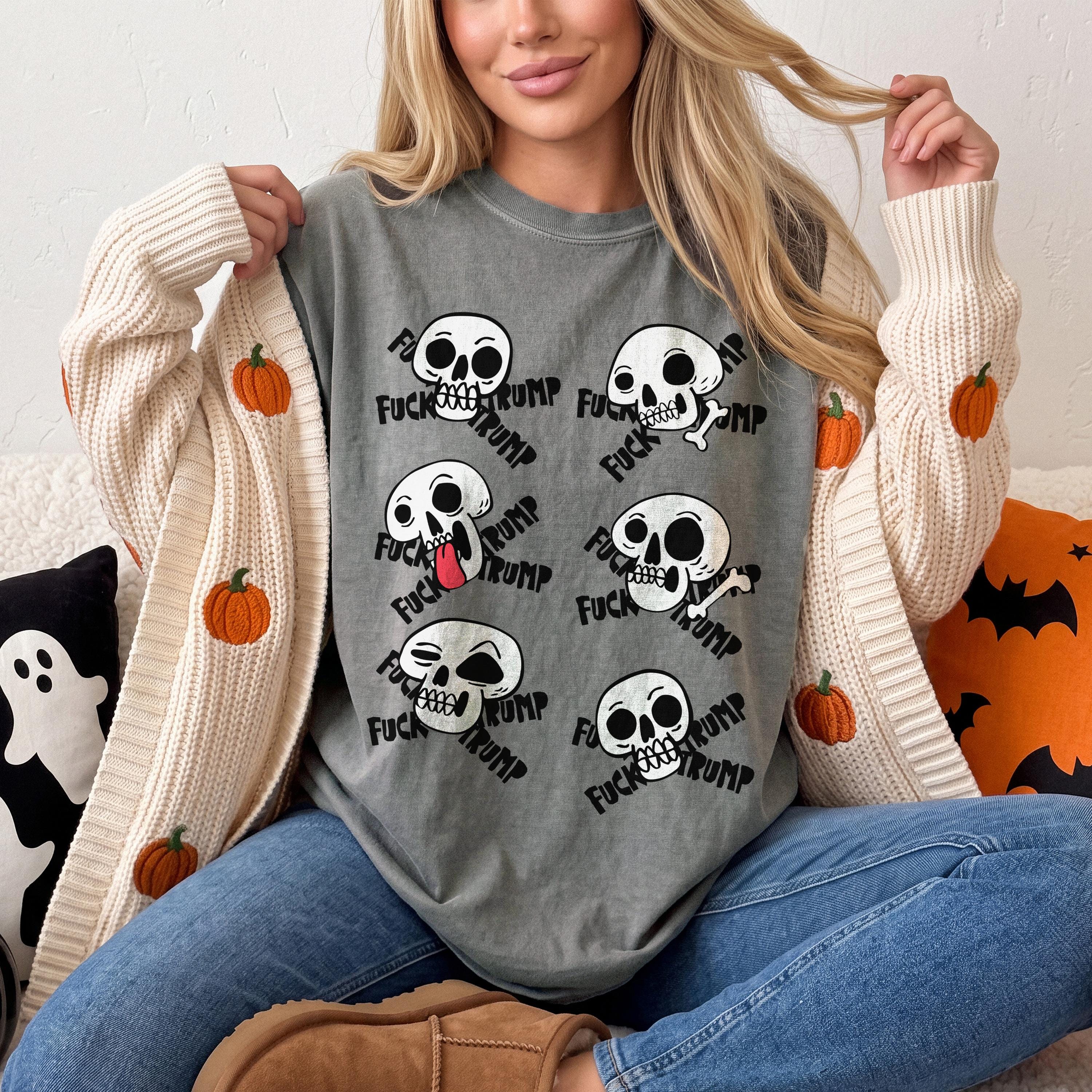 Gray t-shirt with repeating skulls saying &amp;quot;FUCK TRUMP&amp;quot; and pumpkins on cardigan.