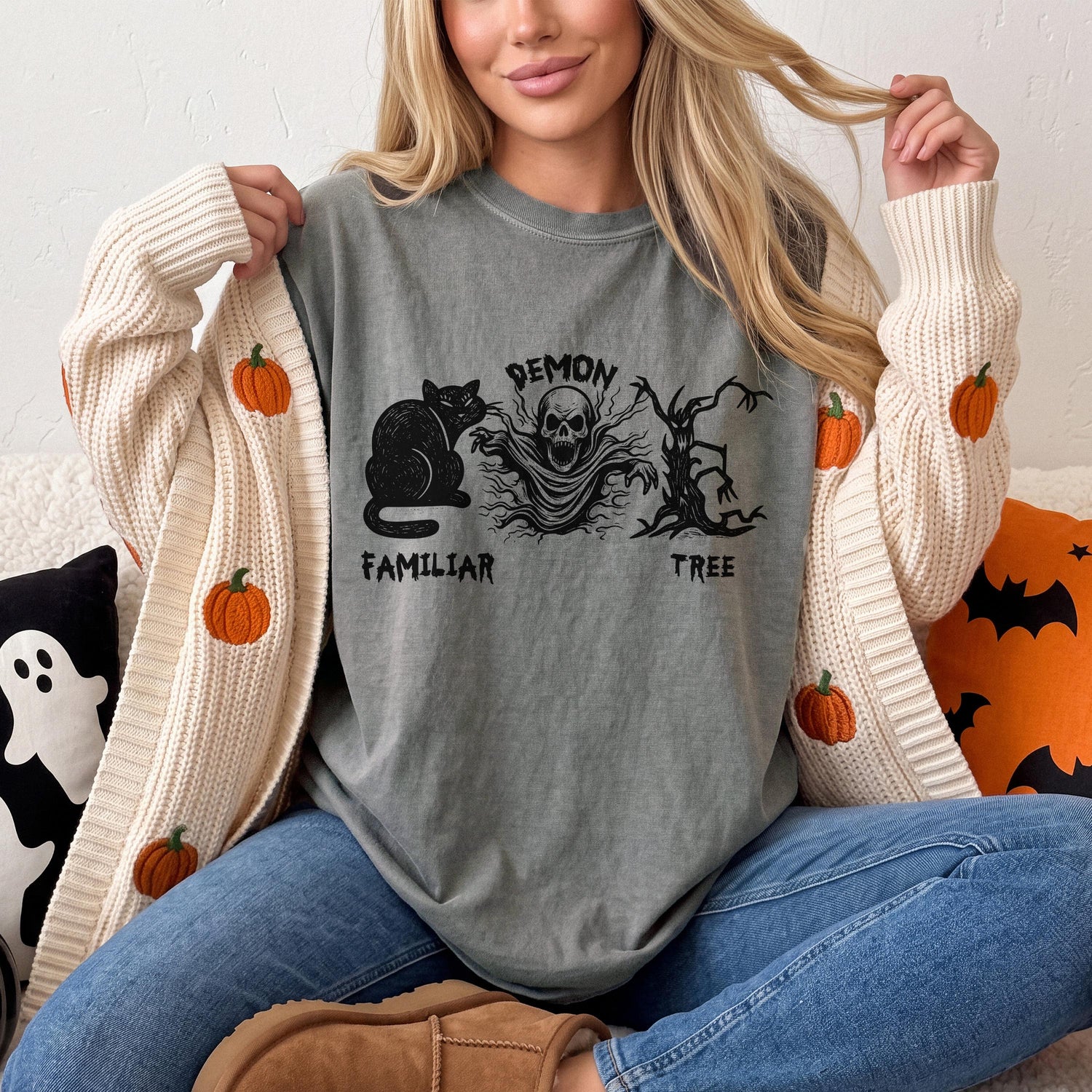 T-shirt with demon, skull, cat, and tree design, with pumpkin-decorated cardigan.