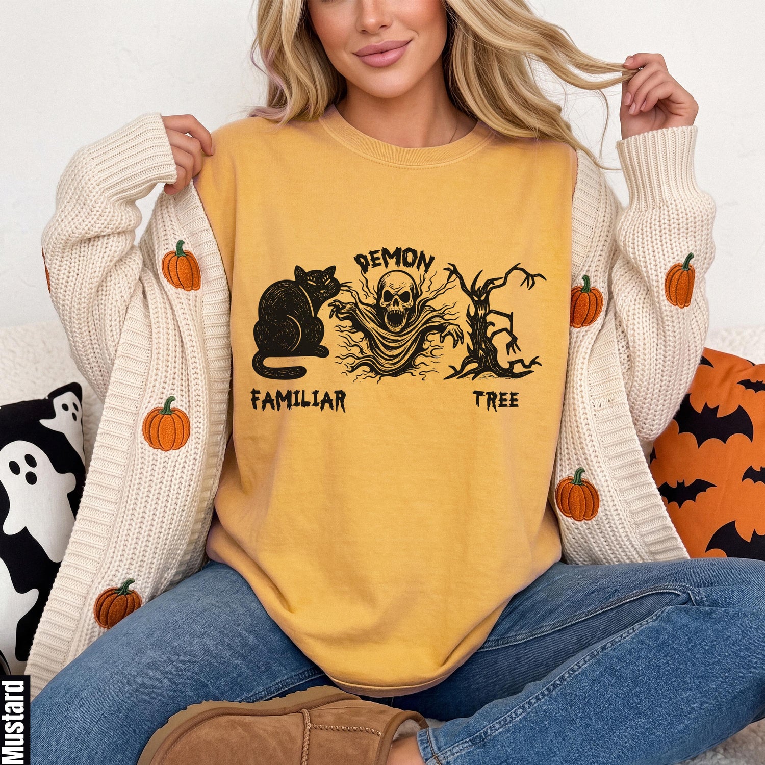 Yellow t-shirt with black Halloween graphic: cat, demon skull, and tree.