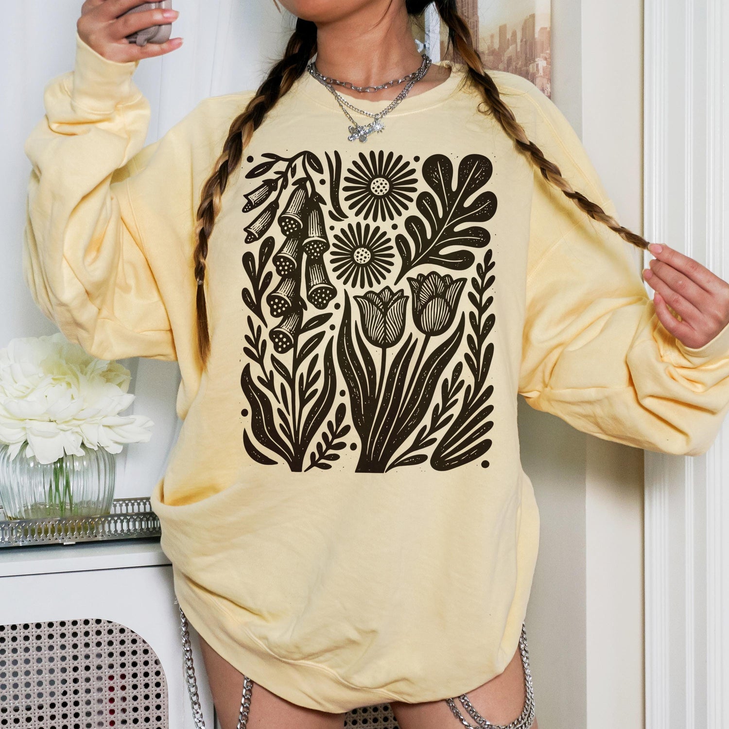 Light yellow crewneck sweatshirt with black floral botanical linocut print.