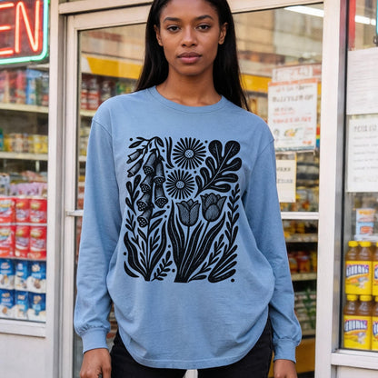 Blue long-sleeve shirt with black graphic of flowers and leaves.