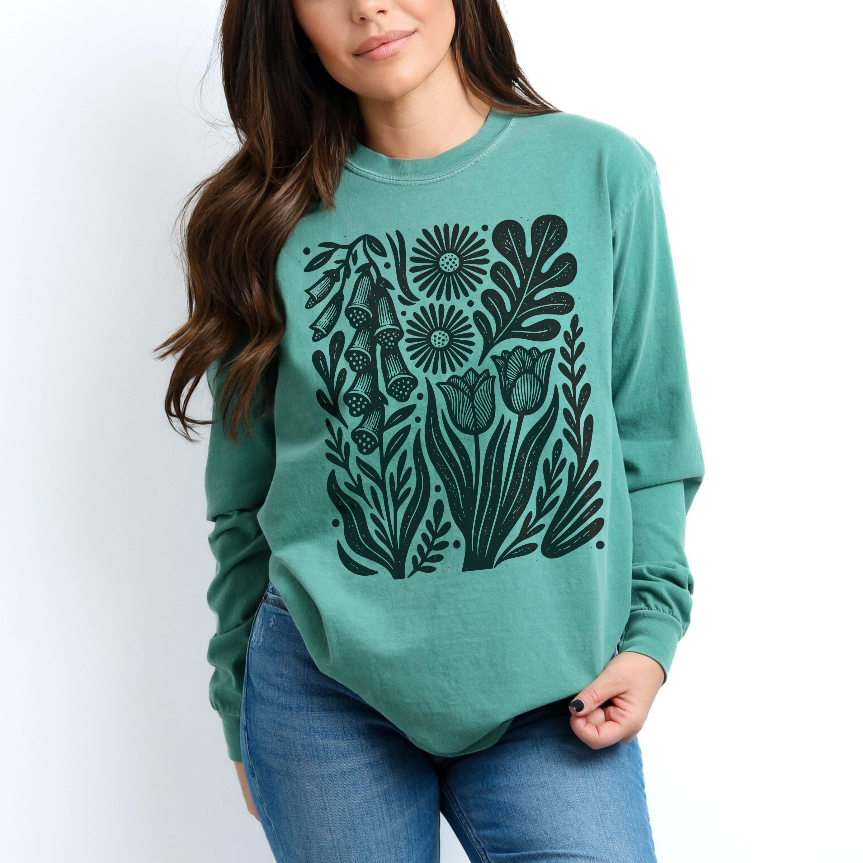 Teal sweatshirt with black floral print featuring tulips and foxgloves.