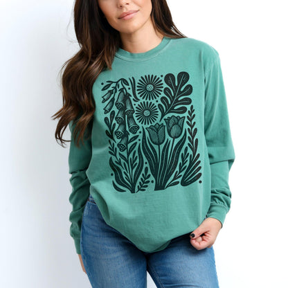 Teal sweatshirt with black floral print featuring tulips and foxgloves.