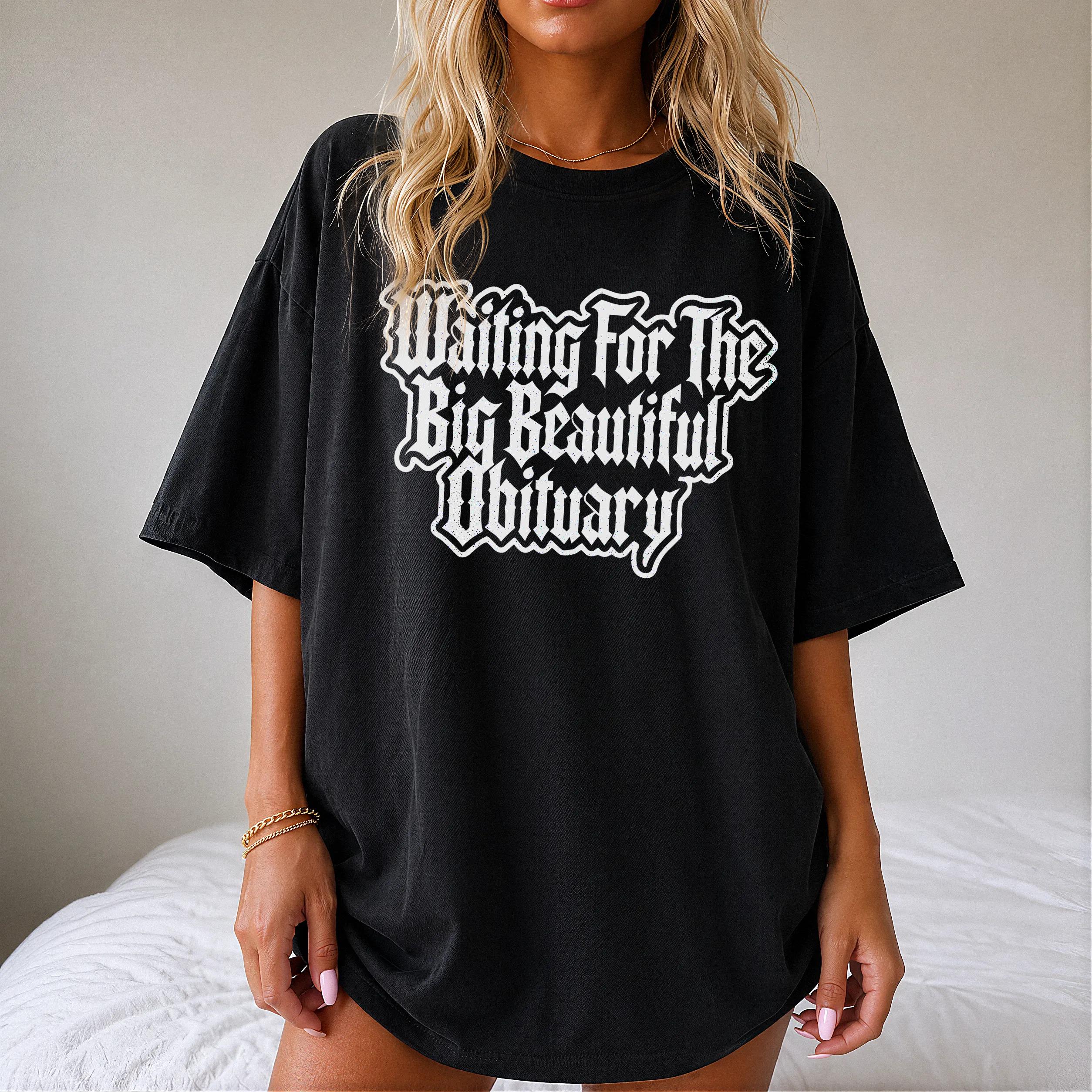 Black t-shirt with white gothic font text &amp;quot;Waiting For The Big Beautiful Obituary&amp;quot;.