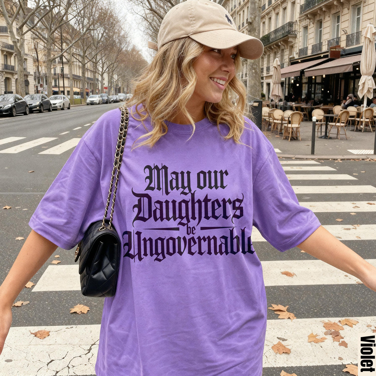 Purple t-shirt with &amp;quot;May our Daughters be Ungovernable&amp;quot; text on a street.