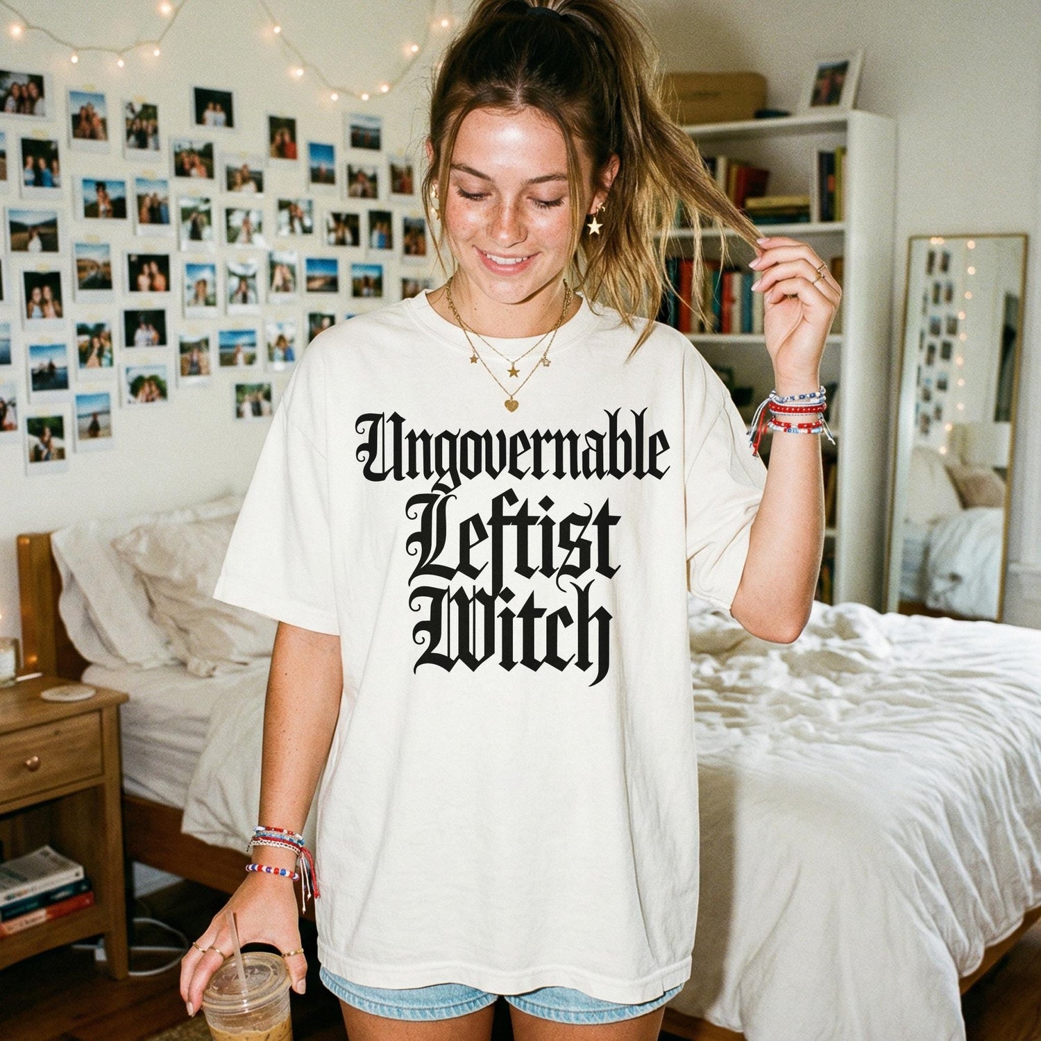 Cream t-shirt with &amp;quot;Ungovernable Leftist Witch&amp;quot; text, worn by a young woman.