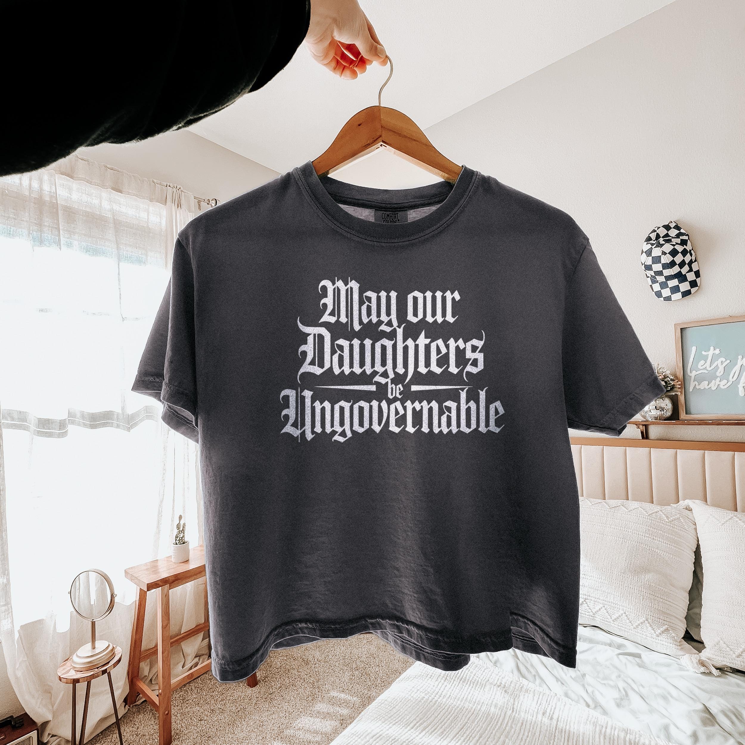 Dark gray t-shirt with &amp;quot;May our Daughters be Ungovernable&amp;quot; text in white gothic font.