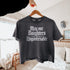 Dark gray t-shirt with "May our Daughters be Ungovernable" text in white gothic font.