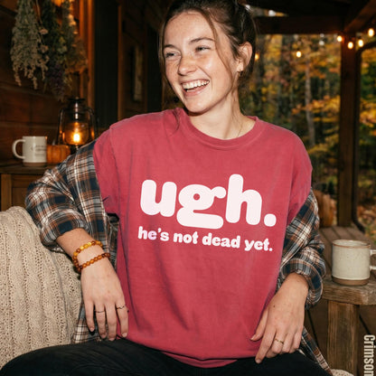 Woman in maroon t-shirt with &amp;quot;ugh. he&amp;
