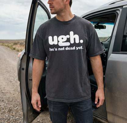 Man wearing dark t-shirt with white text &amp;quot;ugh. he&amp;