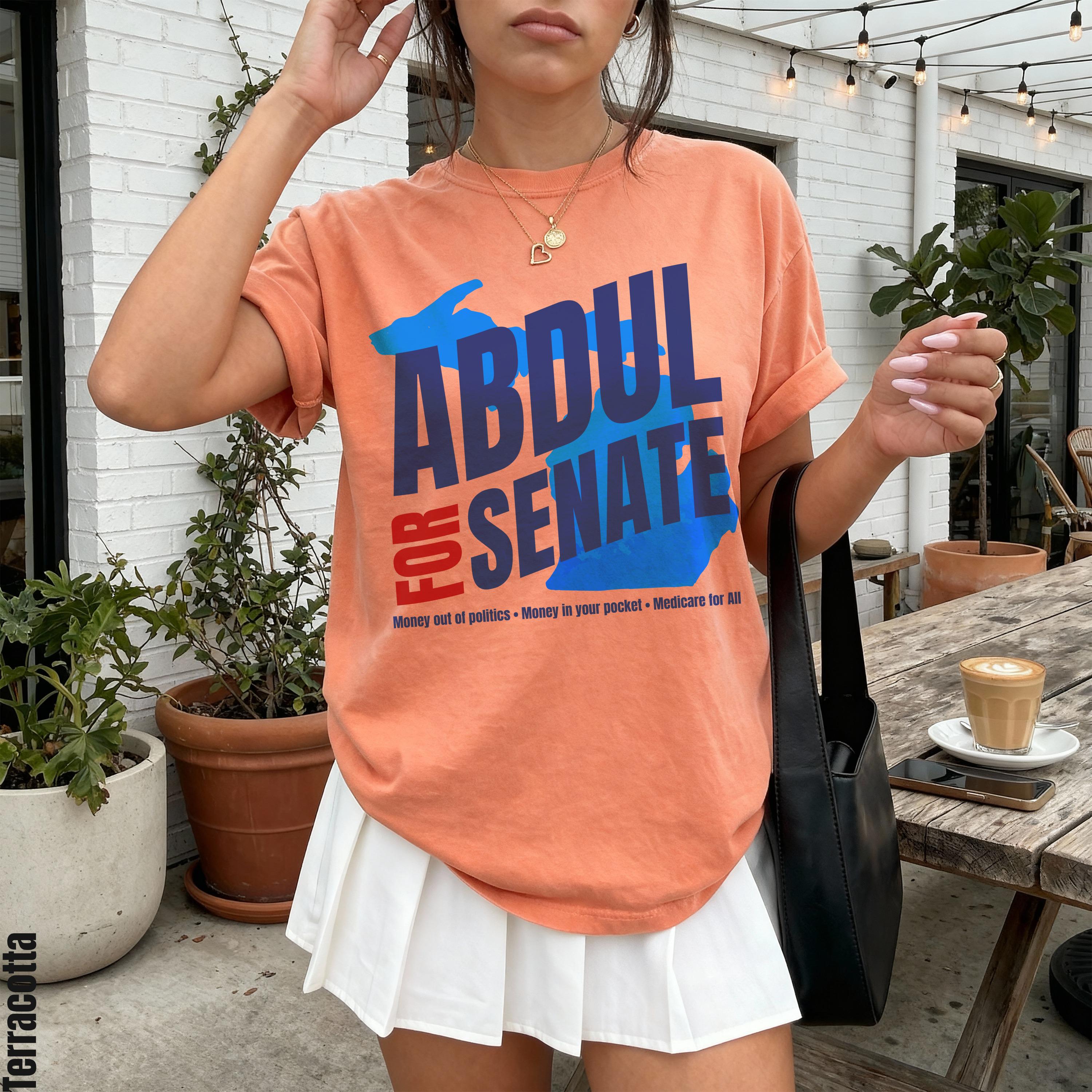 Peach t-shirt with &amp;quot;Abdul for Senate&amp;quot; in blue and red text and campaign slogans.