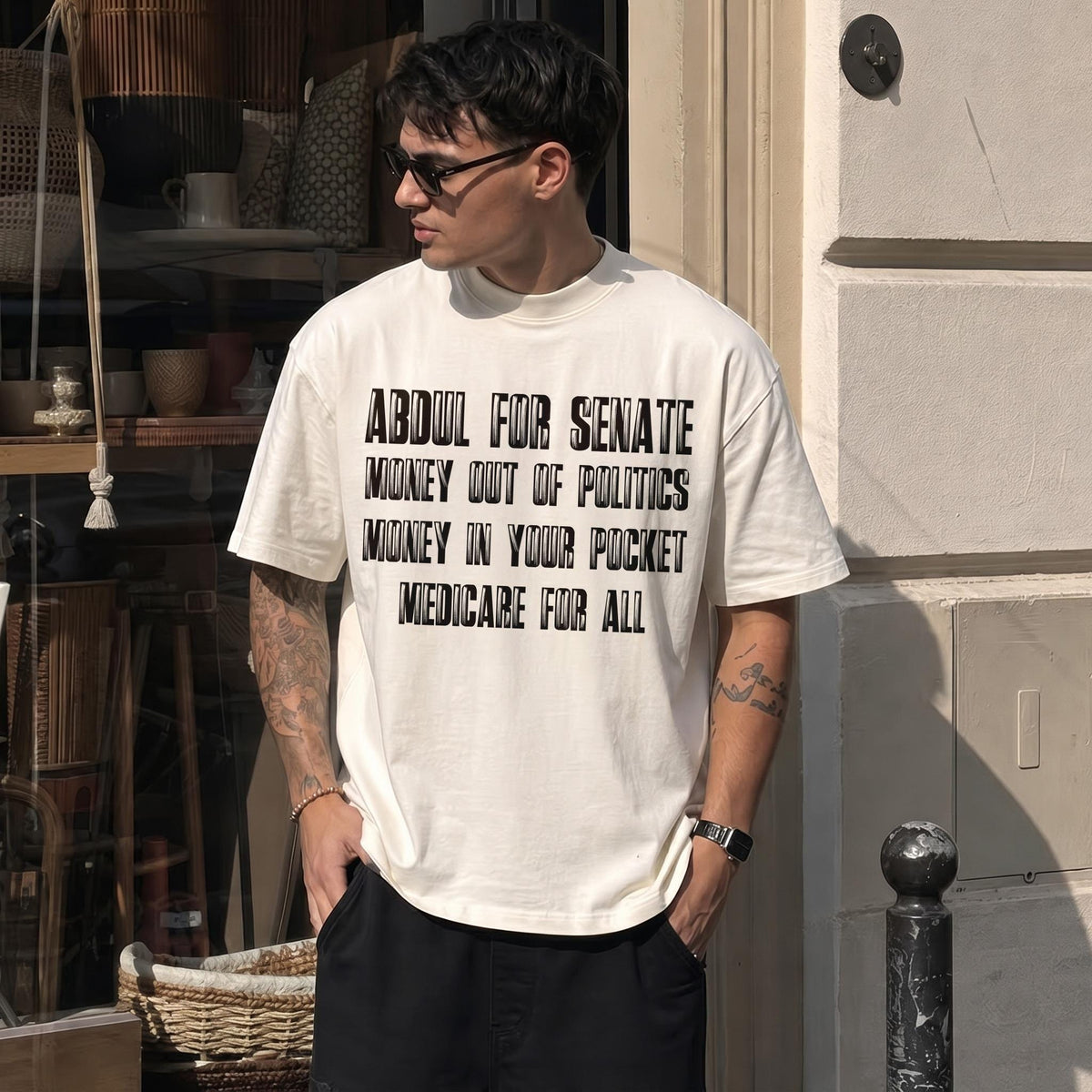 Cream t-shirt with black text: Abdul for Senate, Money Out of Politics, Money In Your Pocket, Medicare for All.