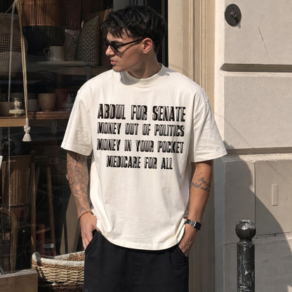 Cream t-shirt with black text: Abdul for Senate, Money Out of Politics, Money In Your Pocket, Medicare for All.