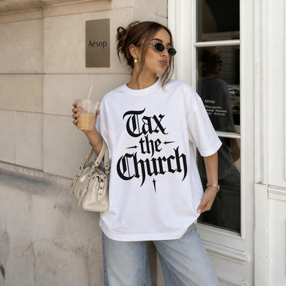 White t-shirt with black gothic text &amp;quot;Tax the Church&amp;quot; held by a woman with sunglasses and a drink.