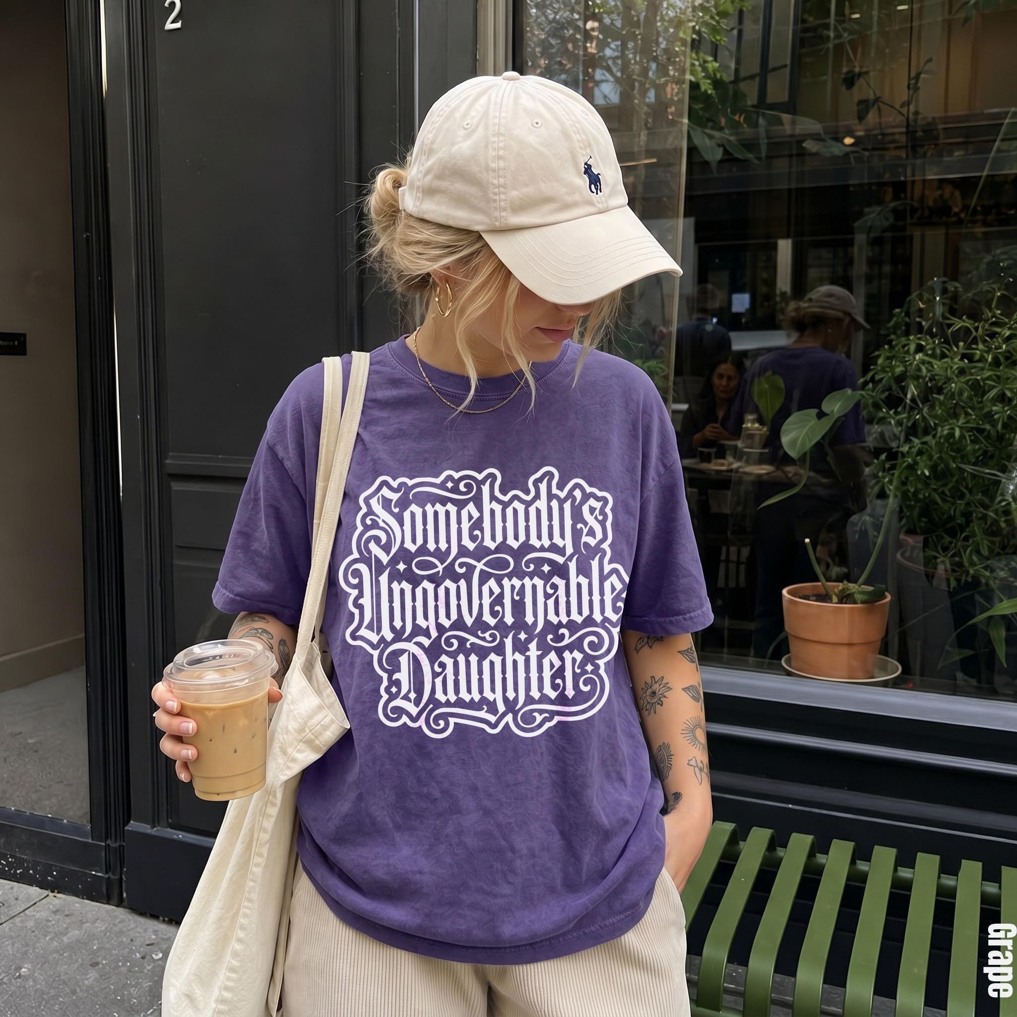 Purple t-shirt with white text &amp;quot;Somebody&amp;