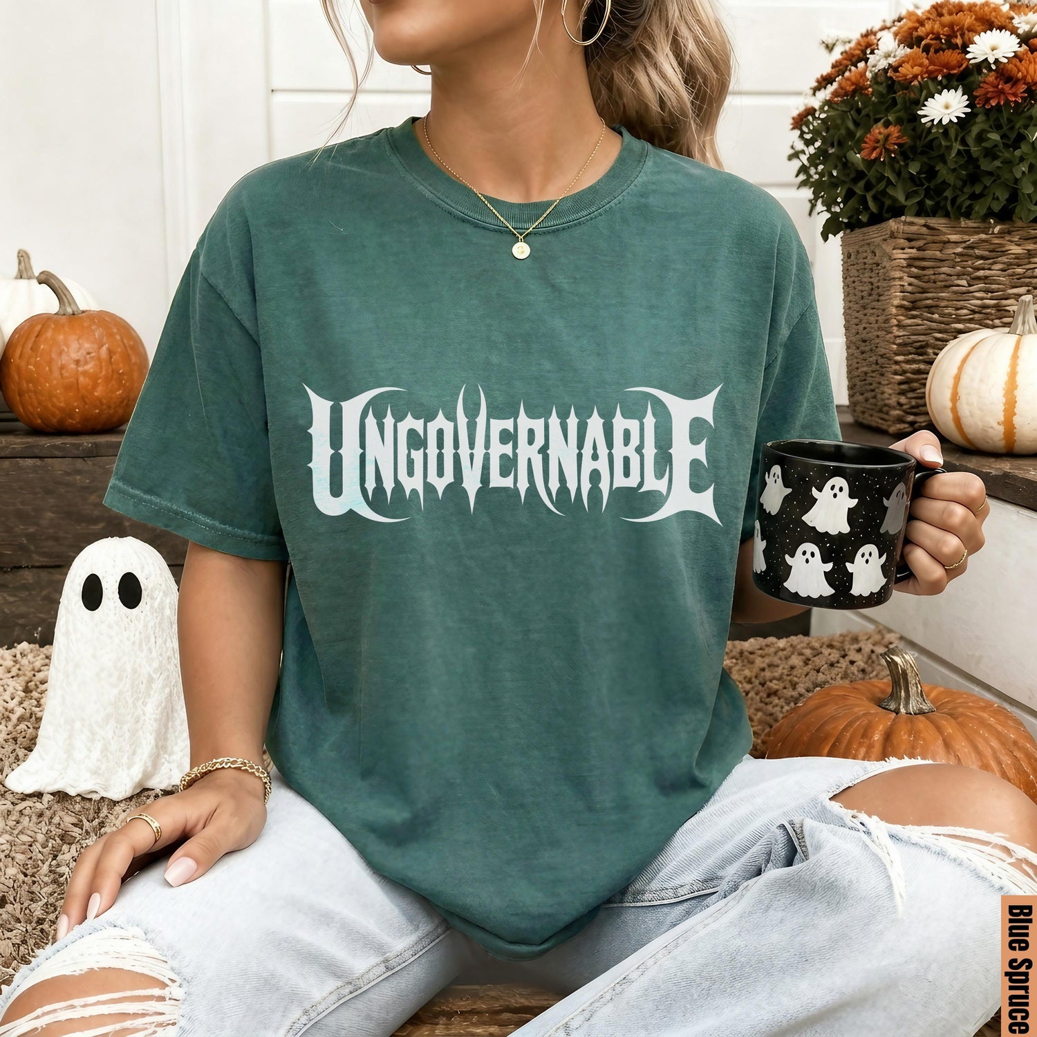 Green t-shirt with &amp;quot;UNGOVERNABLE&amp;quot; graphic, holding a ghost mug, with pumpkins and ghost decor.