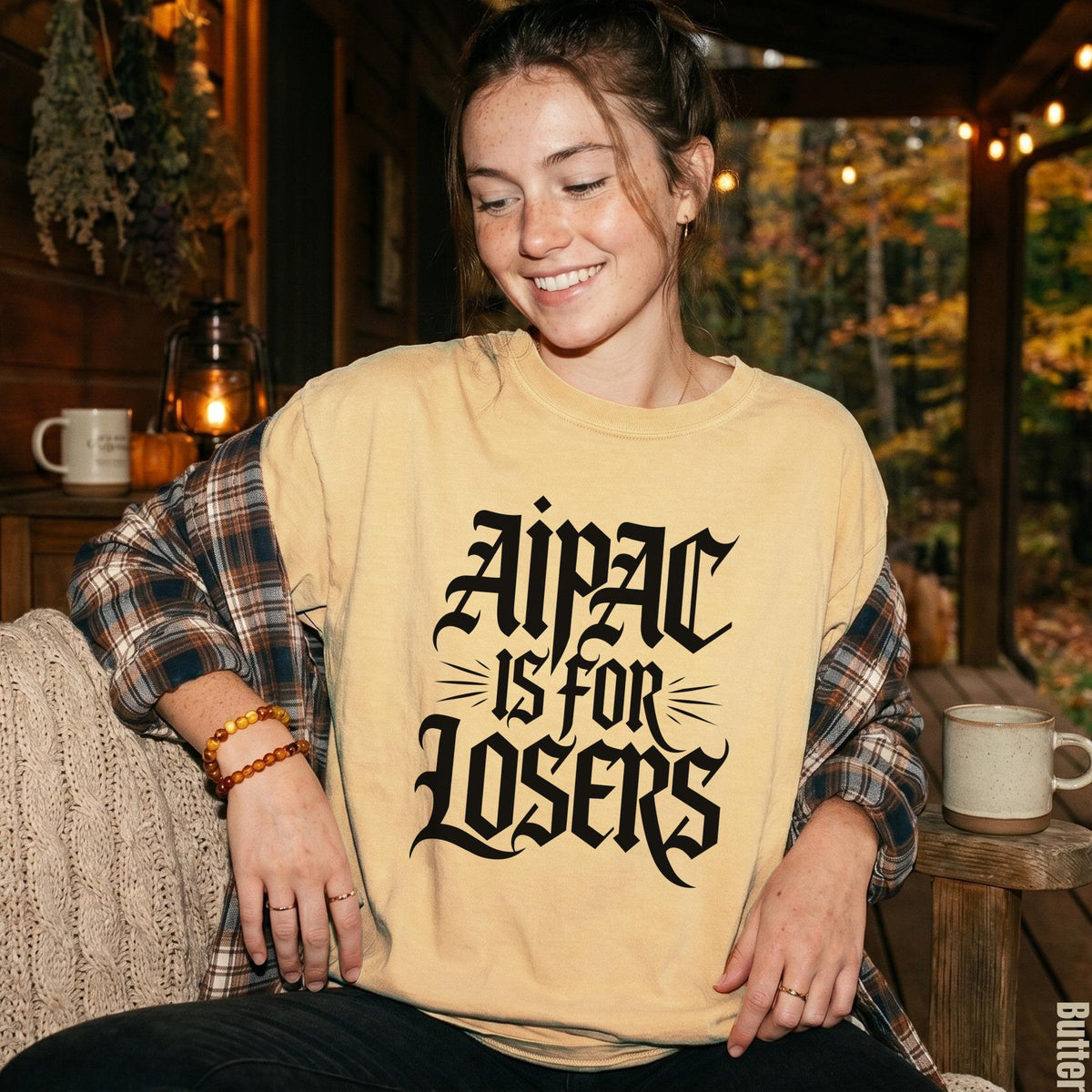 Yellow t-shirt with black gothic text that reads &amp;quot;Aipac is for Losers&amp;quot;.