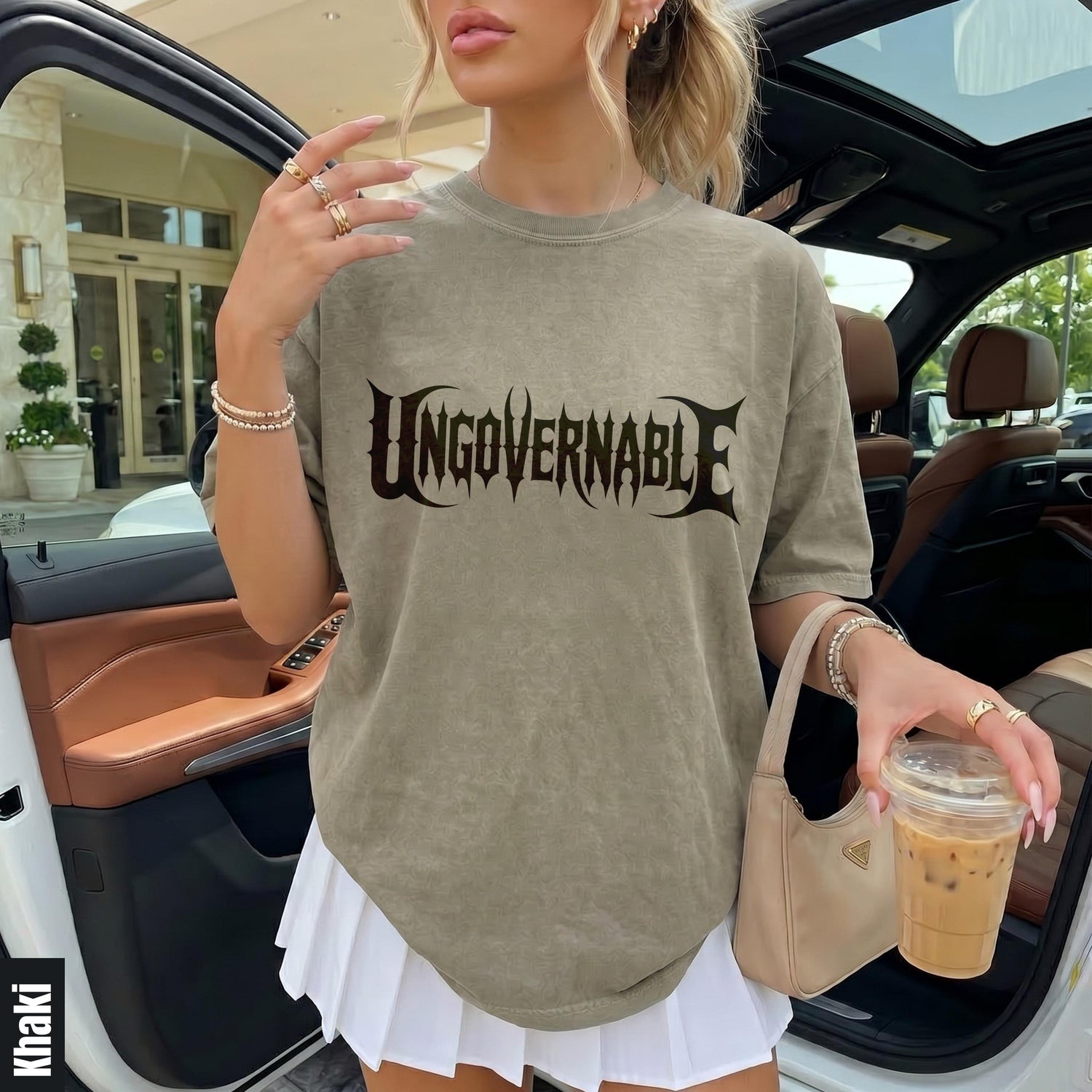 Khaki t-shirt with &amp;quot;Ungovernable&amp;quot; text and white pleated skirt.