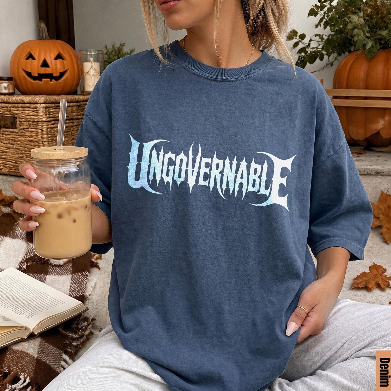 Blue t-shirt with &amp;quot;UNGOVERNABLE&amp;quot; graphic, held by a person with a drink.