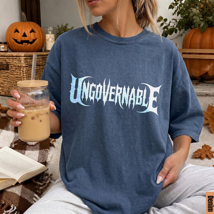 Blue t-shirt with &amp;quot;UNGOVERNABLE&amp;quot; graphic, held by a person with a drink.